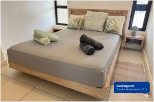 a bed with two pillows on it in a room at SG5 l Le Turquoise - third line building - Beachfront Residence in Cap Malheureux