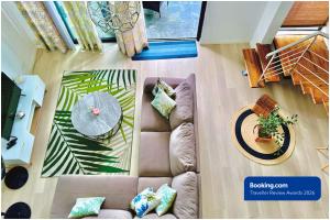 an overhead view of a living room with a couch and a table at SG5 l Le Turquoise - third line building - Beachfront Residence in Cap Malheureux