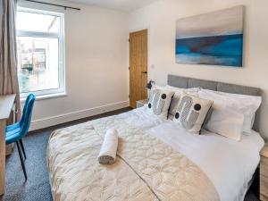 a bedroom with a bed and a desk and a window at Woods Terrace in Gainsborough
