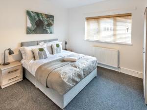 a bedroom with a large bed and a window at Woods Terrace in Gainsborough