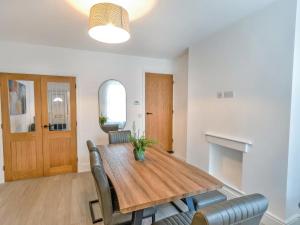 a dining room with a wooden table and chairs at Woods Terrace in Gainsborough