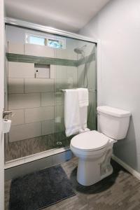 a bathroom with a toilet and a glass shower at Peaceful Mountain Sanctuary near Arrowhead Village in Lake Arrowhead +33 photos