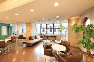 a lobby with a couch and chairs and a table at Yokohama Mandarin Hotel in Yokohama