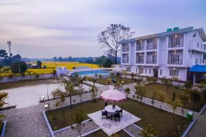 an overhead view of a building with a pink umbrella at Amazon Resort in Sauraha