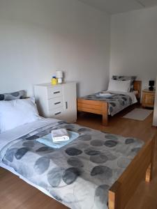 a bedroom with two beds and a dresser at Holiday Home Manuela in Fažana