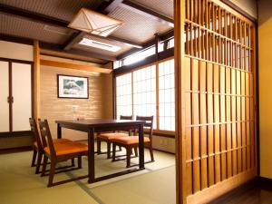 a dining room with a table and chairs at Kurayoshi City Hotel in Kurayoshi
