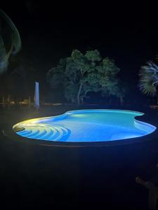 a swimming pool lit up at night at Mwazaro Beach Lodge in Shimoni
