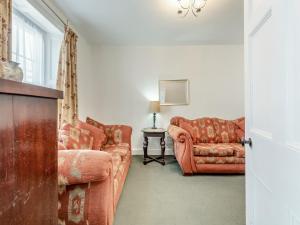a living room with a couch and a chair at Glendower in Aberaeron