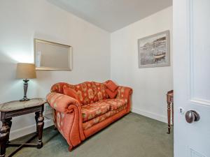 a living room with a couch and a table at Glendower in Aberaeron