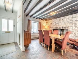 a dining room with a wooden table and chairs at Glendower in Aberaeron