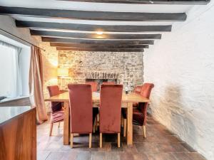 a dining room with a wooden table and chairs at Glendower in Aberaeron