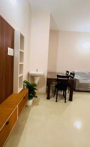 a room with a table and chairs and a bed at City Creek in Perintalmanna