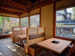 a restaurant with two tables and two windows at Mori no yu Kira No Sato Reopening on December 22, 2025 in Ito