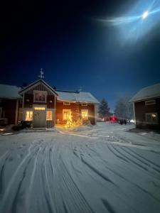 a house in the snow at night at Lapland Heritage Villa in Ranua
