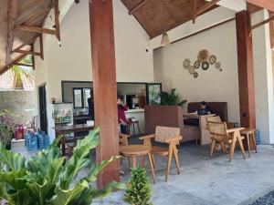 a restaurant with people sitting at tables and chairs at Mini Village in Batukaras