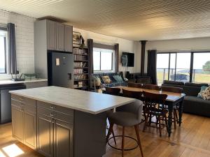 a kitchen and living room with a table and chairs at Fortuna views farm stay in Jumbuk +26 photos