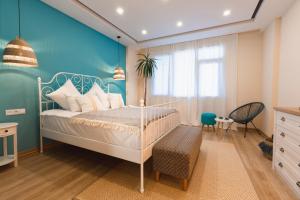 a bedroom with a bed and a blue wall at Sevan Up In in Aghk'ilisa