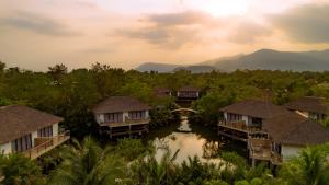 a view of a river with houses and a bridge at Good Time Relax Resort in Kampot