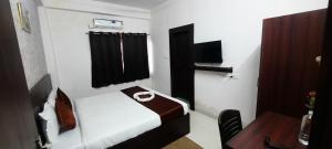 a small room with a bed and a desk at hotel silver fountain in Jāmb