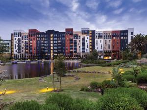 a large building with a lake in front of it at Century City Hotel Bridgewater in Cape Town