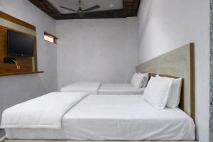 a hotel room with two beds and a tv at The Shree Ganesh Hotel in Khātu