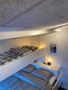 a bedroom with a bunk bed and a desk at Glentevej idyl in Assens