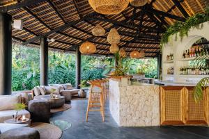 a bar in a restaurant with chairs and tables at Ycona Eco-Luxury Resort, Zanzibar in Dikoni