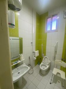a bathroom with a toilet and a sink at العييري للشقق المخدومة حائل 3 in Hail