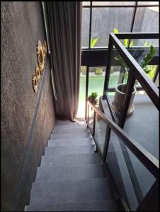 a staircase with a butterfly on the side of a building at Wolu Designer Loft - Private Pool & Tropical Garden, Canggu in Tumbak Bayuh