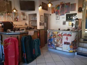 a restaurant with a counter and some luggage at Hôtel Confort 09 ou HC-09 in Tarascon-sur-Ariège