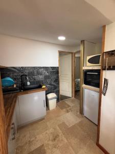 a kitchen with a sink and a stove top oven at Location l'îlot tropical in Le Bois de Nèfles