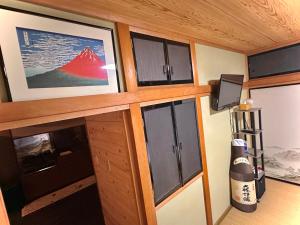 a room with wooden cabinets and a wall with windows at Gen-en Private Hideaway Villa, Izu Forest in Izu