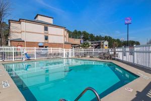 a large swimming pool with a white fence at Sleep Inn & Suites Stockbridge Atlanta South in Stockbridge
