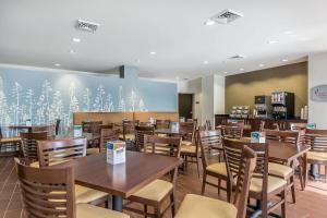 a dining room with tables and chairs in a restaurant at Sleep Inn & Suites O'Fallon MO - Technology Drive in O'Fallon