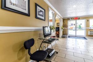 a office with a computer and a chair in a room at Rodeway Inn & Suites Jacksonville near Camp Lejeune in Jacksonville
