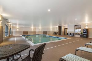 a pool in a hotel room with chairs and a table at The Clocktower Hotel Latham - North Albany, an Ascend Collection Hotel in Cohoes