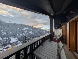 a balcony with a view of a snow covered mountain at Cocon Alpin: Vue Imprenable, Central & Calme in Saint-Luc +10 photos
