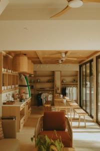 a living room with a lot of tables and chairs at TWIN PALMS 'Beach House' - New surf front location in Thulusdhoo