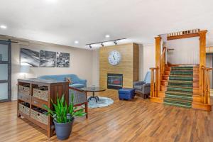 a living room with a staircase and a fireplace at Country Inn & Suites by Radisson, Jacksonville - Orange Park in Orange Park