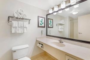 a white bathroom with a sink and a mirror at Country Inn & Suites by Radisson, Jacksonville - Orange Park in Orange Park