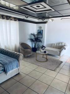 a living room with a couch and a table at Euphoria Escape in Midrand