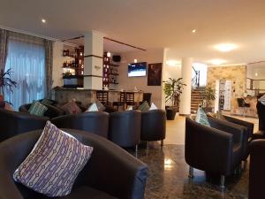 a bar with couches and chairs in a room at Hotel Celeste Ethiopia in Addis Ababa