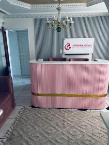 a lobby with a pink counter with a sign on it at Euphoria Escape in Midrand