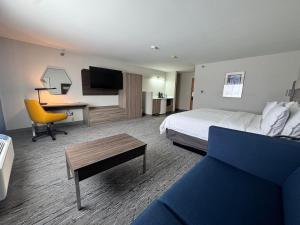 a hotel room with a bed and a desk at Holiday Inn Express Deforest Madison Area by IHG in De Forest