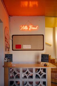 a sign on the wall of a restaurant with a table at Friends Hostel in Tbilisi City