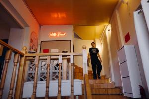 a woman walking down the stairs in a building at Friends Hostel in Tbilisi City