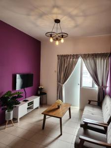 a living room with a couch and a tv at The Cave - Adults Only in Tanah Rata +45 photos