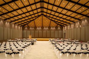 a large banquet hall with rows of tables and chairs at The Shore Trishvam in Pondicherry +88 photos