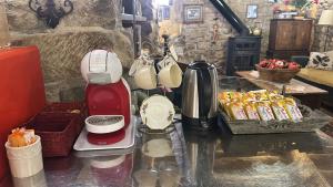 a kitchen counter with a coffee maker and some food at El Callejon De Andrese in Loarre +16 photos
