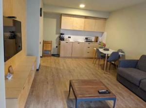 a living room with a couch and a table at Koktha-Mitarbi Resort Block 1 Appt 215 in Bakuriani